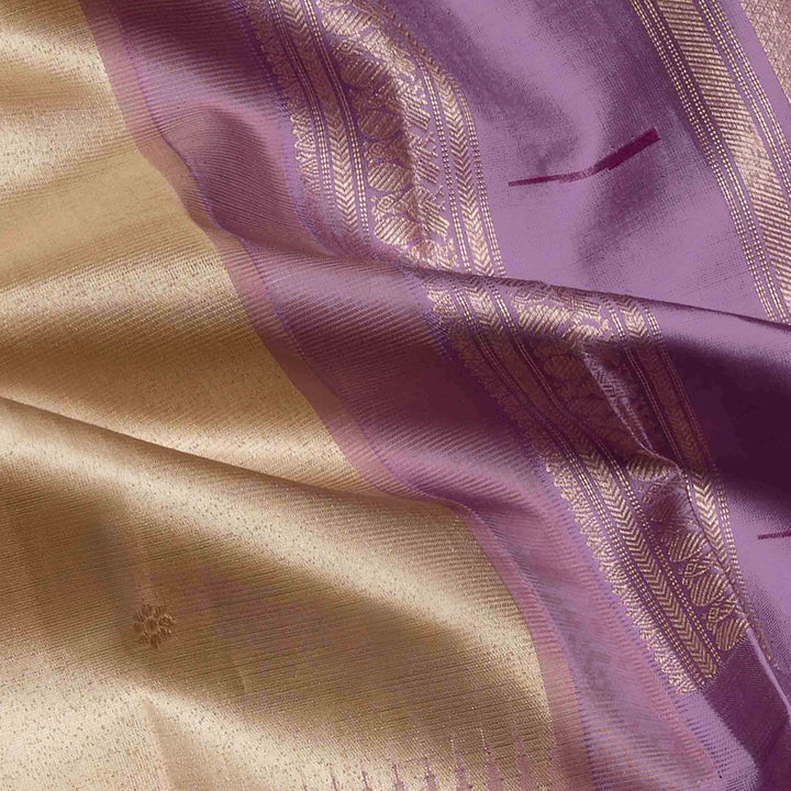 Cream Kanjivaram silk saree with tissue body, silver zari floral butta, lavender Paithani border and annam design pallu with matching blouse
