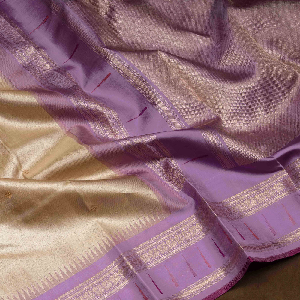Cream Kanjivaram silk saree with tissue body, silver zari floral butta, lavender Paithani border and annam design pallu with matching blouse