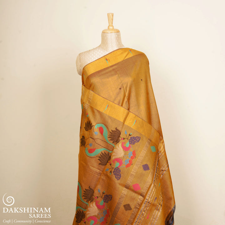 Mustard tussar silk Paithani saree with dotted body, gold zari border and multicolor bird jamdani pallu with matching blouse