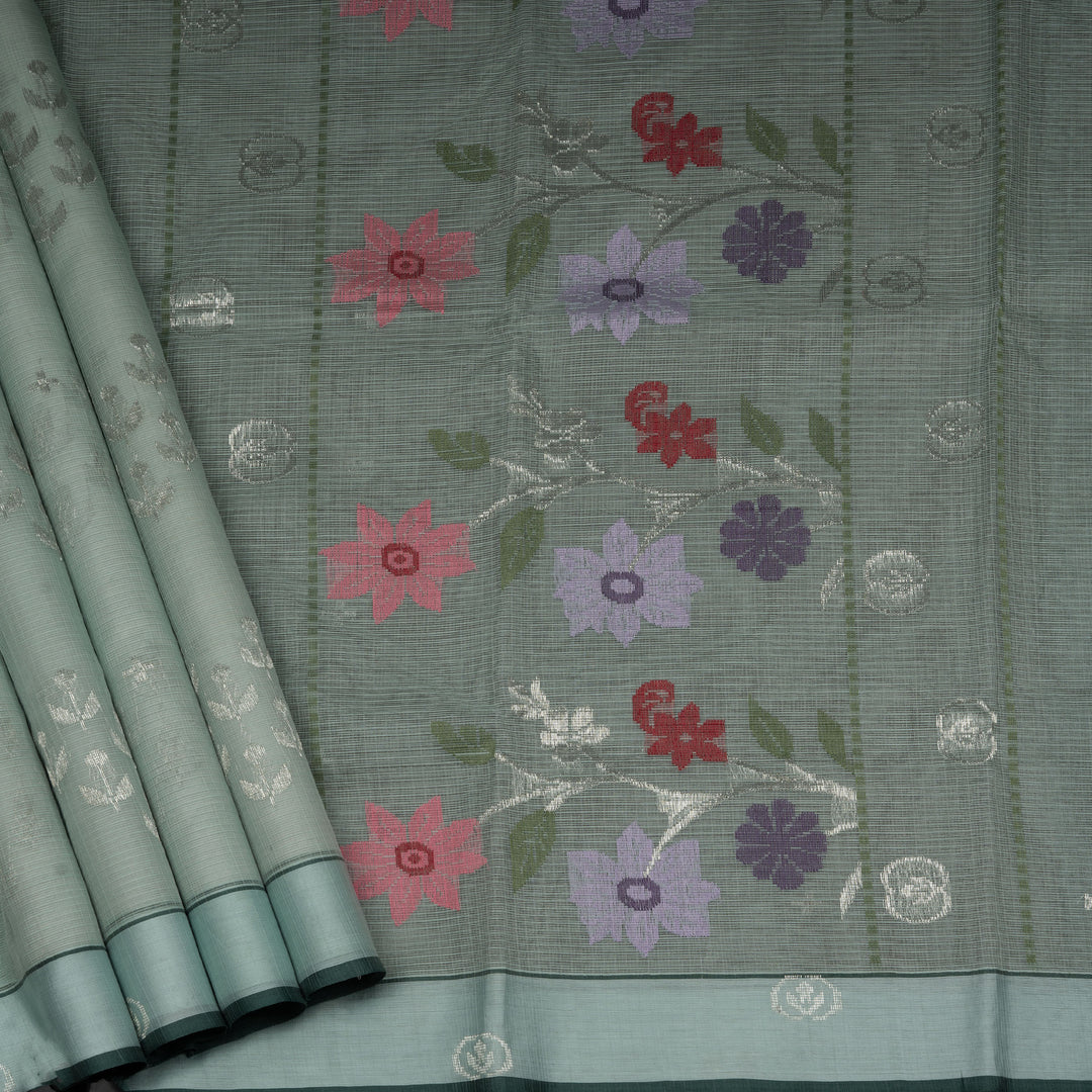 Moss green Kota doria silk saree with silver zari floral motifs, monotone border and pallu with silk thread flowers and chevron blouse