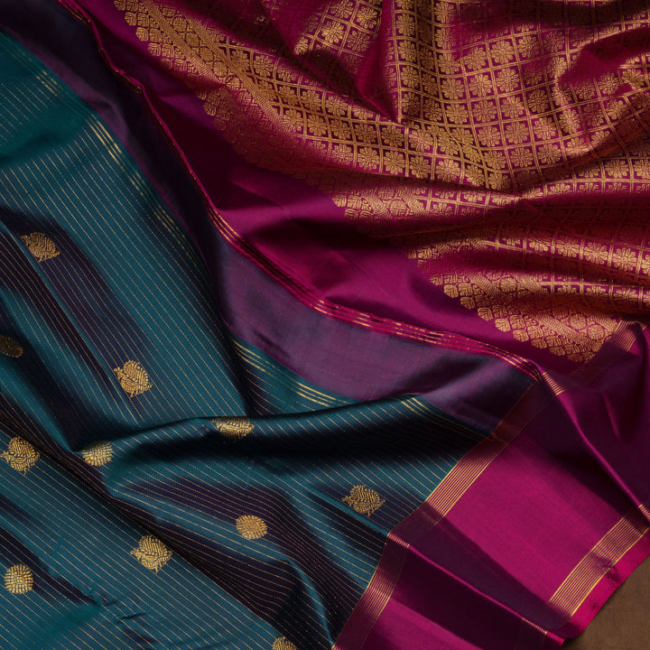 Peacock green Kanjivaram silk saree with gold zari stripes, annam and chakram butta, magenta rettapet border and detailed pallu with matching blouse