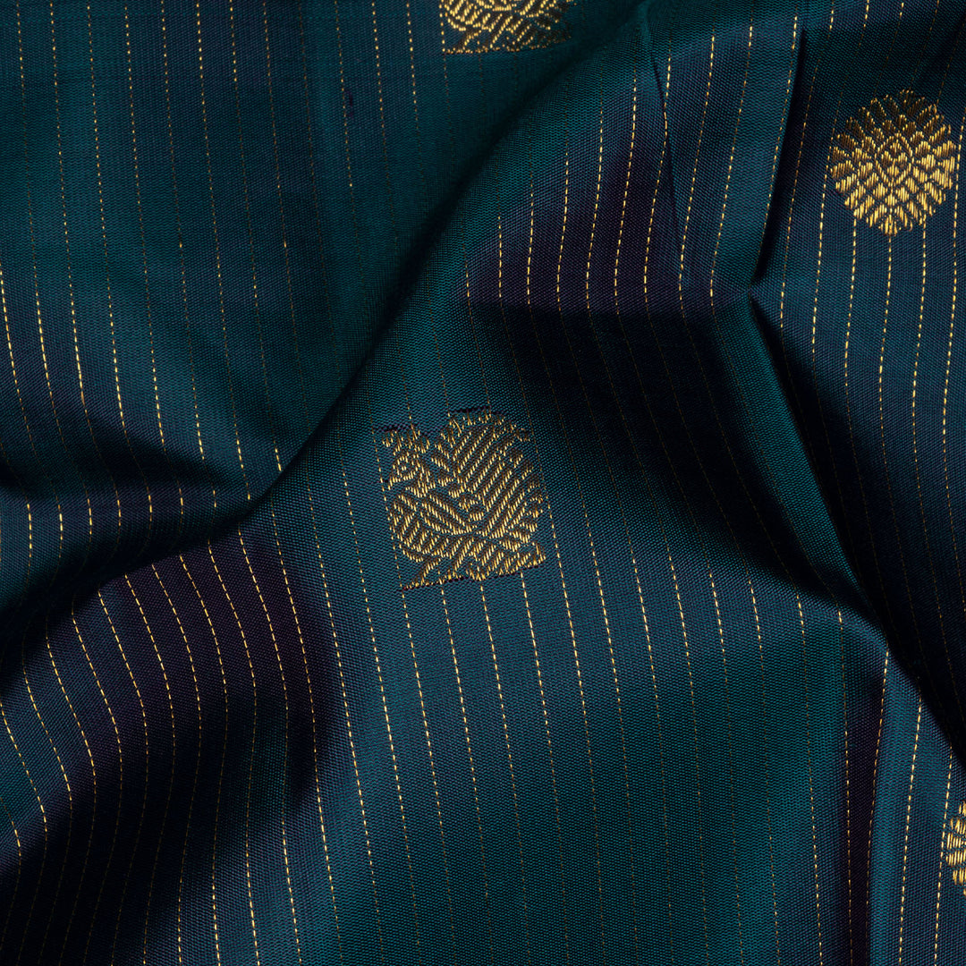 Peacock green Kanjivaram silk saree with gold zari stripes, annam and chakram butta, magenta rettapet border and detailed pallu with matching blouse