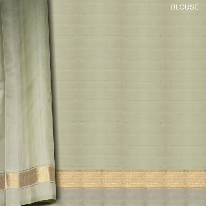 Light green Kanjivaram silk saree with gold zari diagonal chevron lines and striped panel pallu with matching blouse