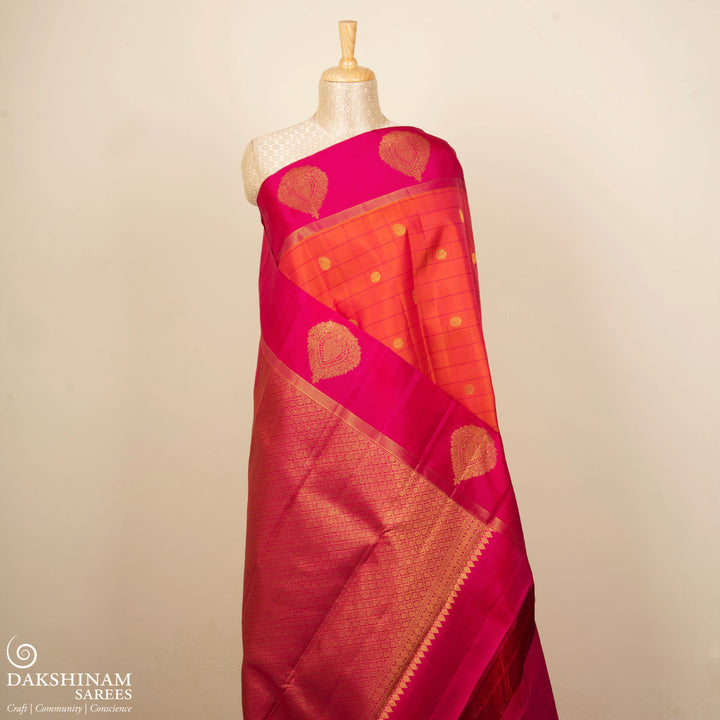 Orange Kanjivaram silk saree with checks, chakram and mango butta, magenta leaf border and vaira mookuthi pallu with matching blouse