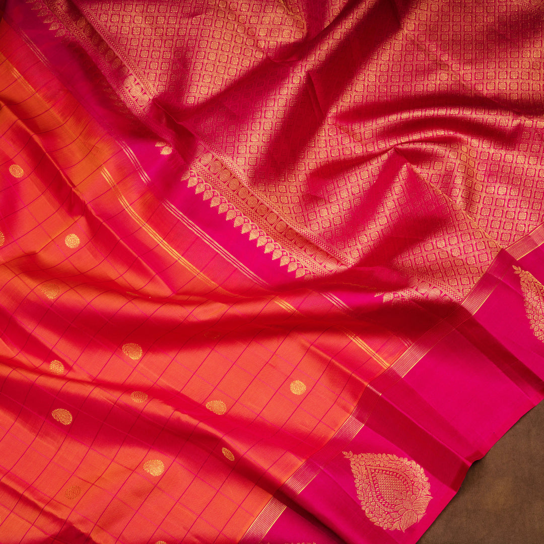 Orange Kanjivaram silk saree with checks, chakram and mango butta, magenta leaf border and vaira mookuthi pallu with matching blouse
