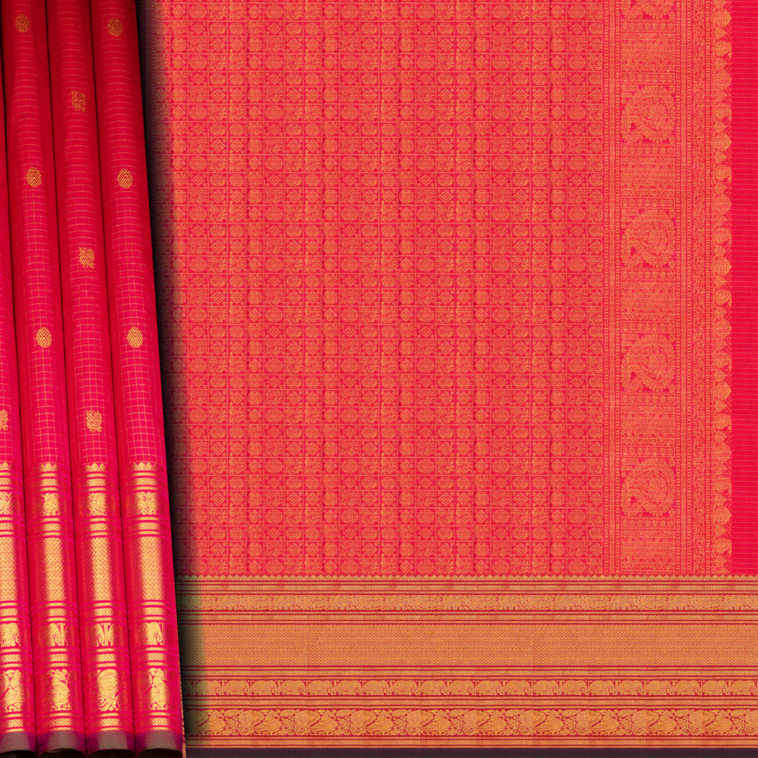 Reddish pink Kanjivaram silk saree with vairoosi checks, annam and rudraksham butta, green korvai border and rich traditional pallu with matching blouse