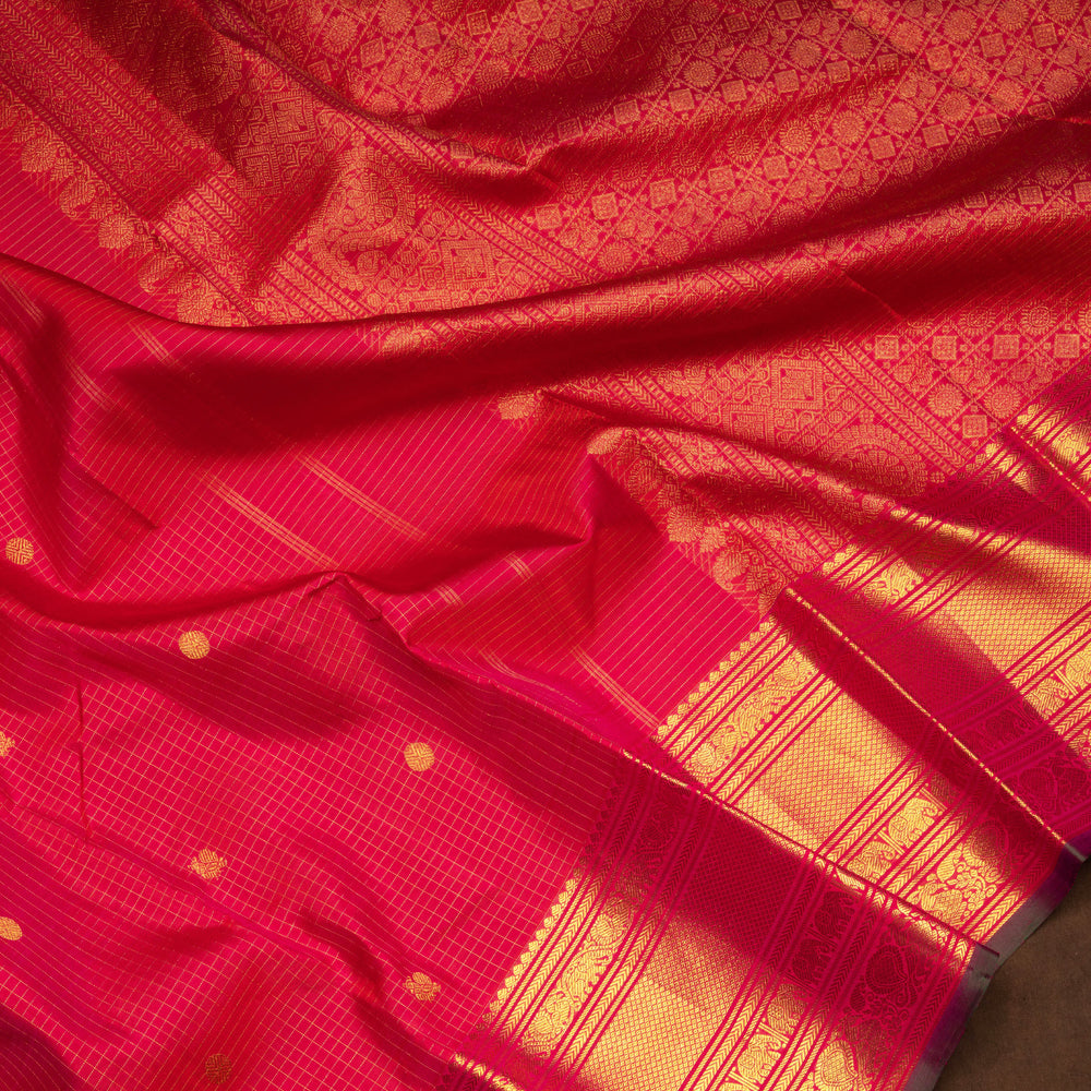 Reddish pink Kanjivaram silk saree with vairoosi checks, annam and rudraksham butta, green korvai border and rich traditional pallu with matching blouse