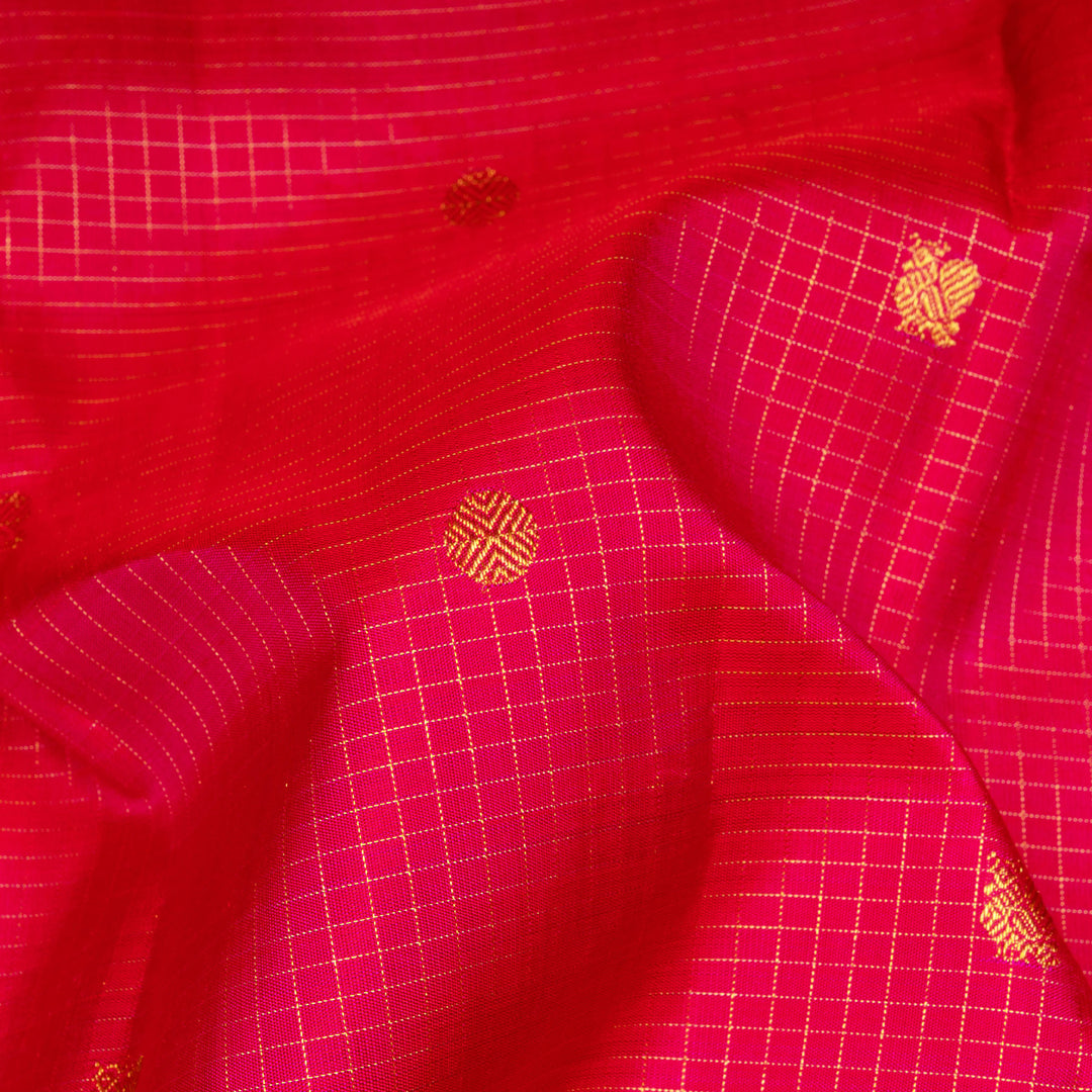 Reddish pink Kanjivaram silk saree with vairoosi checks, annam and rudraksham butta, green korvai border and rich traditional pallu with matching blouse