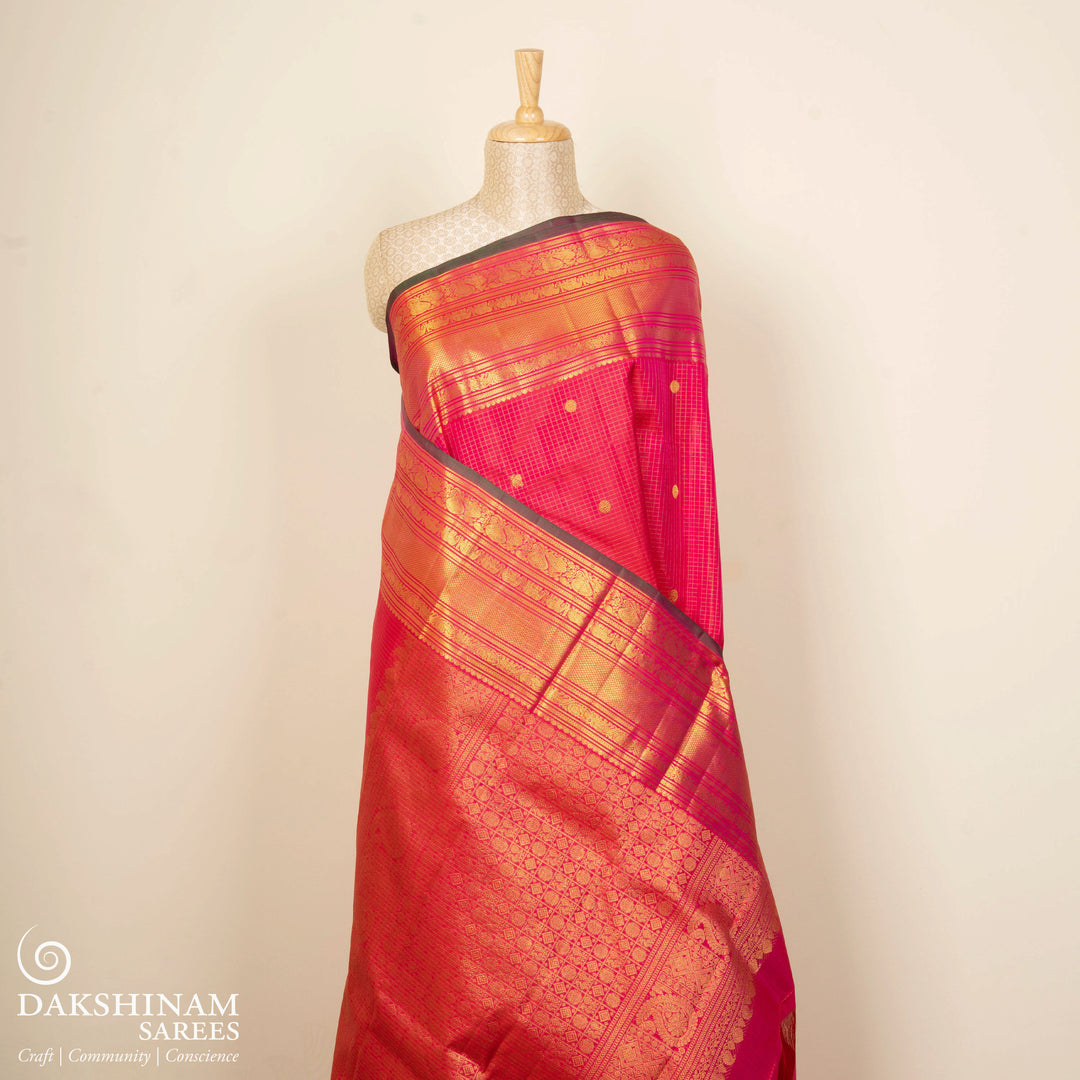 Reddish pink Kanjivaram silk saree with vairoosi checks, annam and rudraksham butta, green korvai border and rich traditional pallu with matching blouse