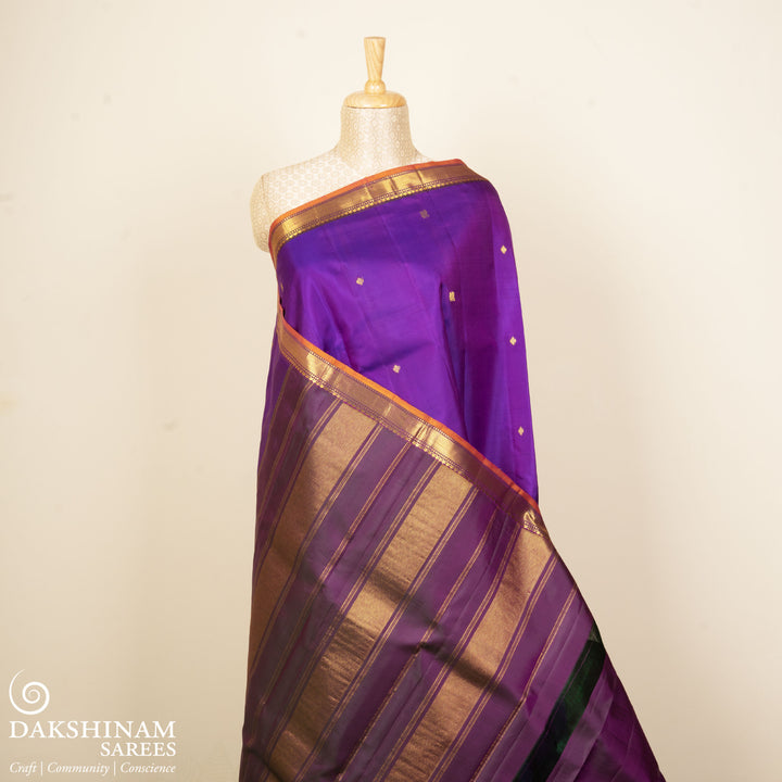 Violet Kanjivaram silk saree with diamond and annam butta, orange chevron border and gold zari striped pallu with contrast blouse
