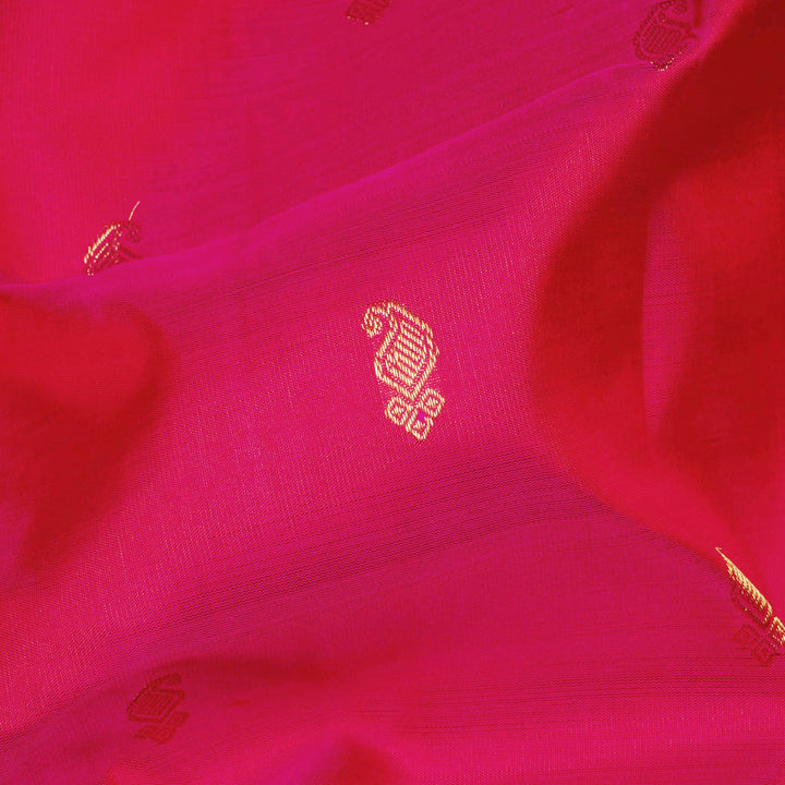 Pink Kanjivaram silk saree with gold zari mango butta, light pink pallu with peacock and elephant motifs, and matching blouse