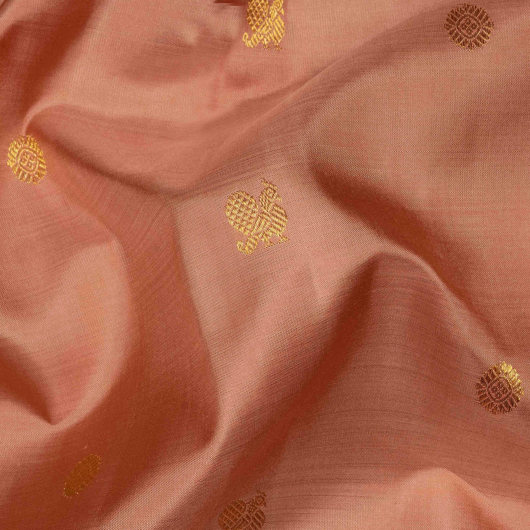 Beige peach Kanjivaram silk saree with annam and chakram butta, gold zari lined pallu and matching monotone blouse