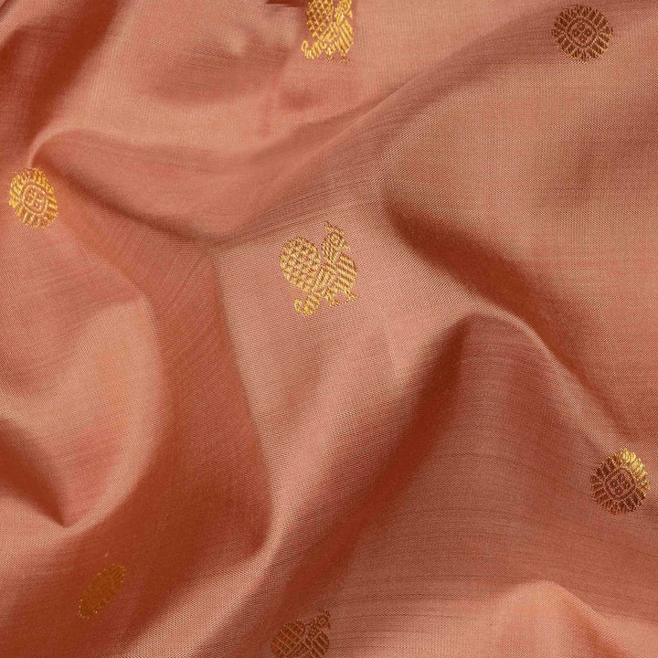 Beige peach Kanjivaram silk saree with annam and chakram butta, gold zari lined pallu and matching monotone blouse