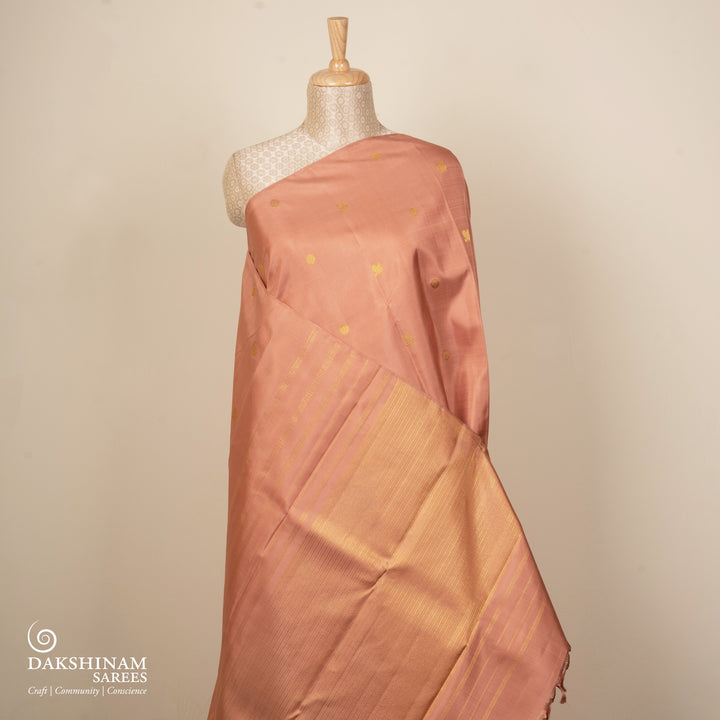 Beige peach Kanjivaram silk saree with annam and chakram butta, gold zari lined pallu and matching monotone blouse