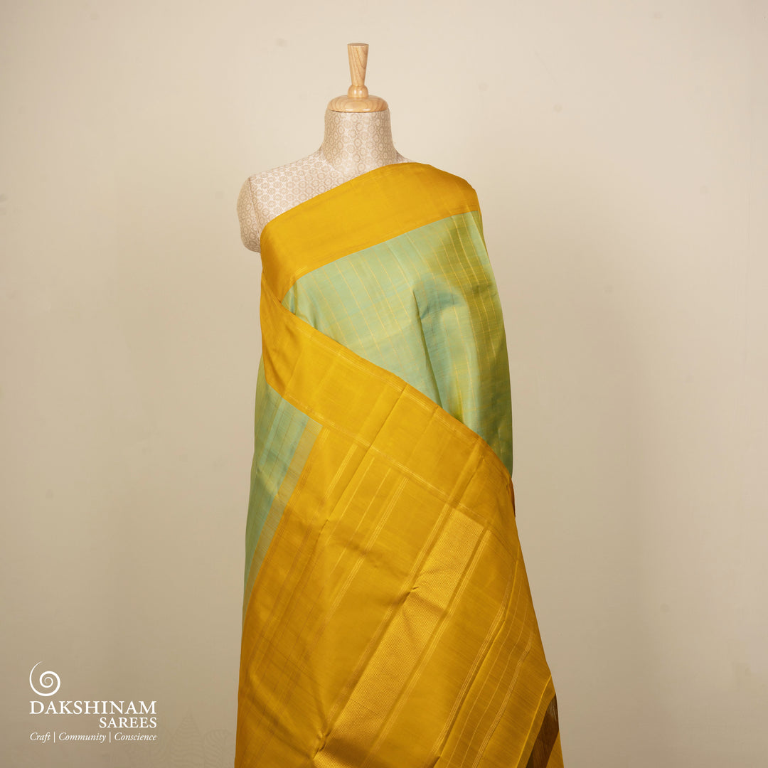 Dual-tone Sea green Kanjivaram silk saree with big checks, yellow rettapet border and gold lined pallu with matching blouse