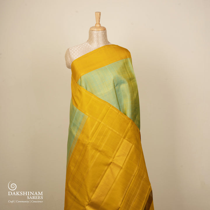 Dual-tone Sea green Kanjivaram silk saree with big checks, yellow rettapet border and gold lined pallu with matching blouse