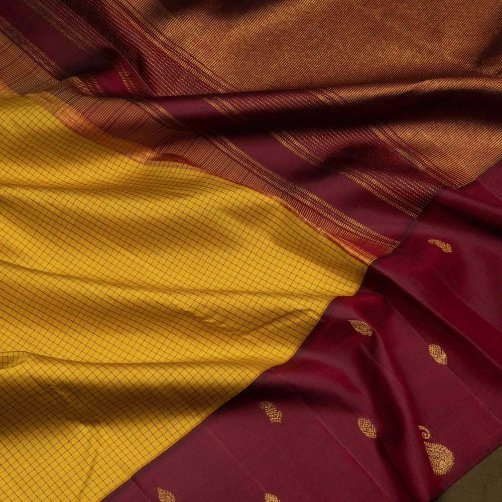 Yellow Kanjivaram silk saree with maroon checks, floral and mango butta border, and panel line pallu with matching blouse
