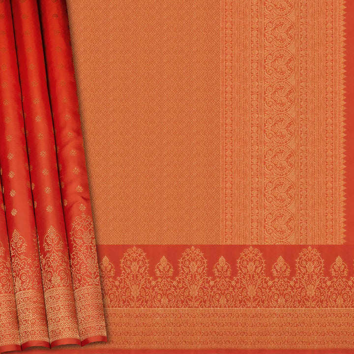 Orange Kanjivaram silk saree with allover diamond butta, turning border and rich pallu with rudraksham, chevron lines and retta killi motifs