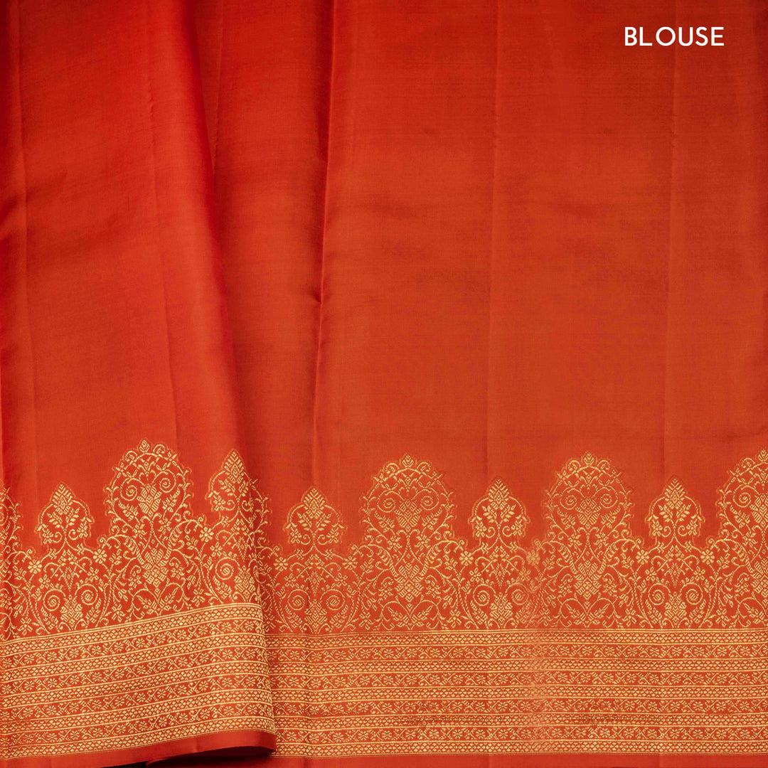 Orange Kanjivaram silk saree with allover diamond butta, turning border and rich pallu with rudraksham, chevron lines and retta killi motifs