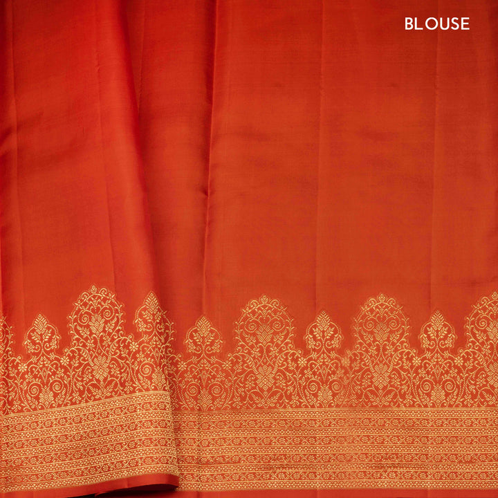 Orange Kanjivaram silk saree with allover diamond butta, turning border and rich pallu with rudraksham, chevron lines and retta killi motifs
