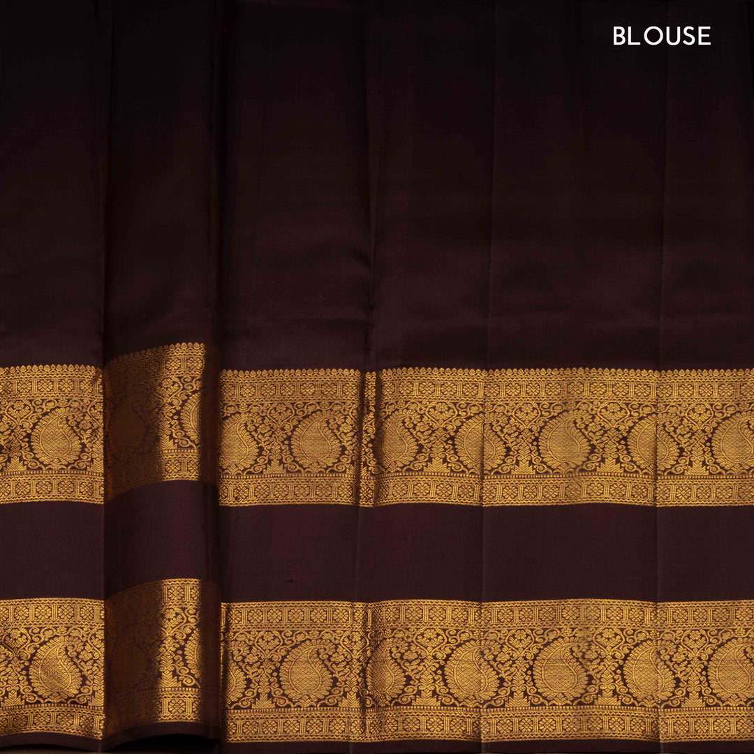 Rust orange Kanjivaram silk saree with annam and chakram butta, brown rettapet border and rich traditional pallu with matching blouse