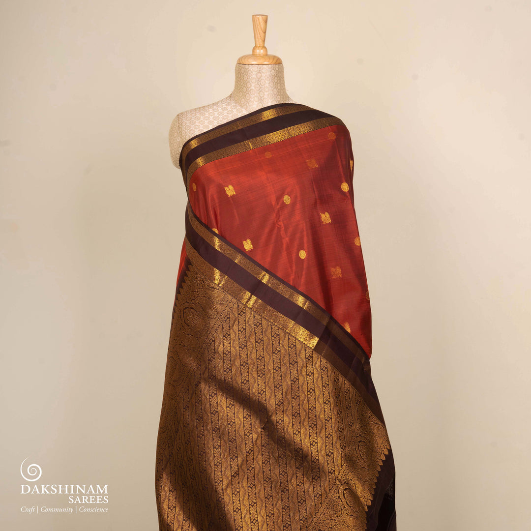Rust orange Kanjivaram silk saree with annam and chakram butta, brown rettapet border and rich traditional pallu with matching blouse