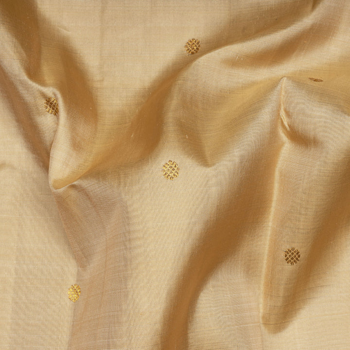 Cream Kanjivaram silk saree with chakram buttas, peacock blue border featuring chevron, rudraksham and floral lines, paired with plain blue blouse.