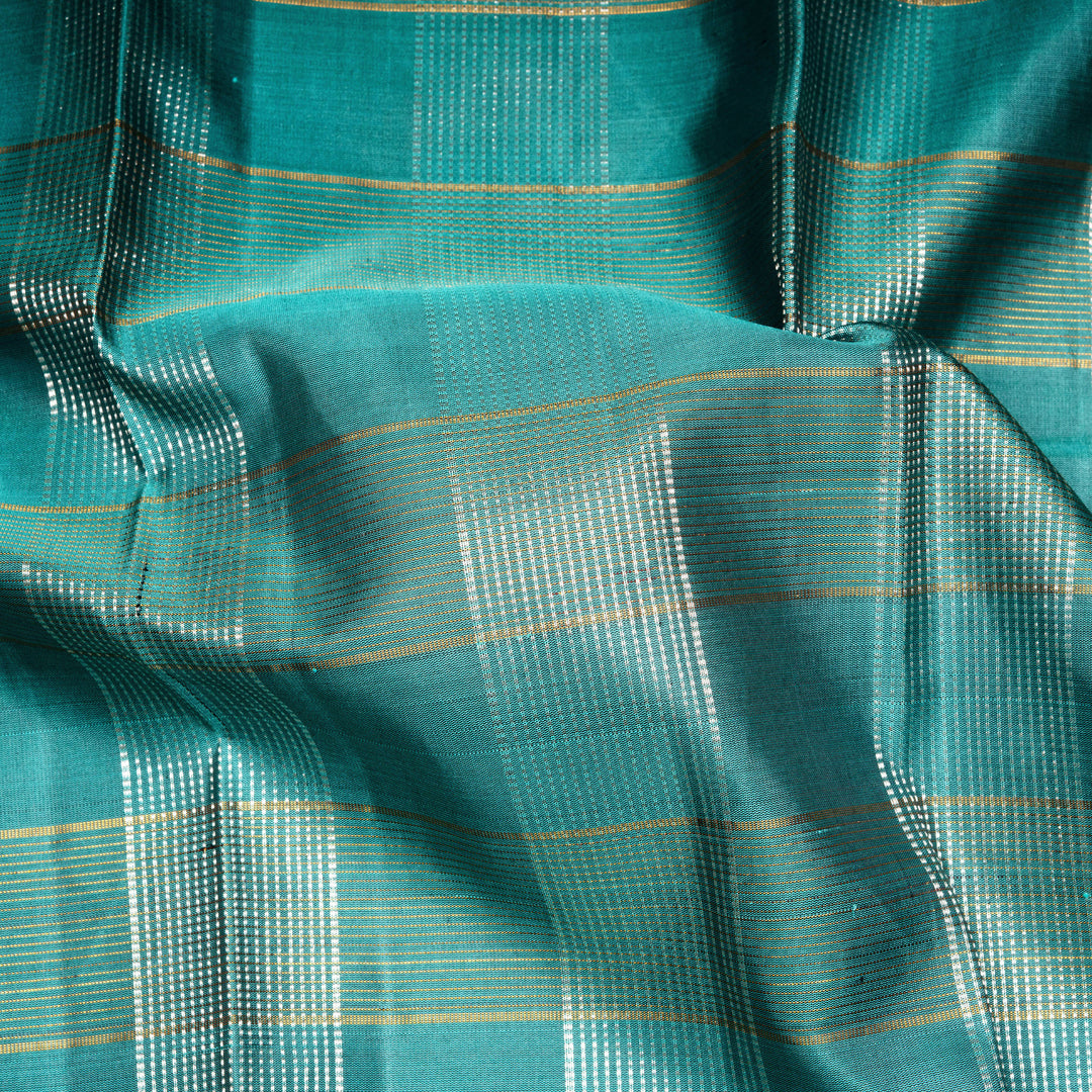 Aqua blue Kanjivaram silk saree with gold and silver zari checks, taupe brown temple border and matching blouse