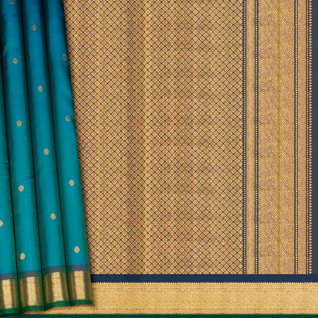 Peacock blue Kanjivaram silk saree with floral butta, dark blue zari border and diamond panel pallu with matching blouse