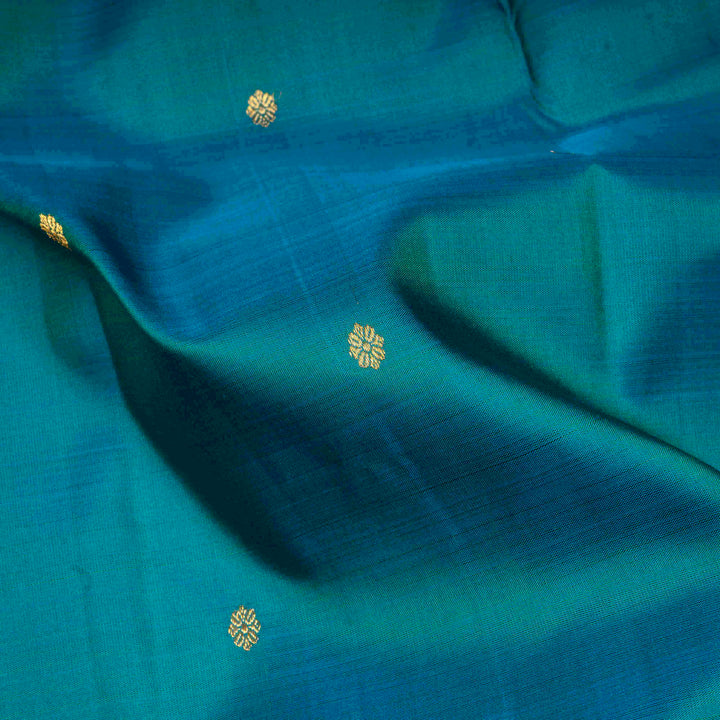 Peacock blue Kanjivaram silk saree with floral butta, dark blue zari border and diamond panel pallu with matching blouse