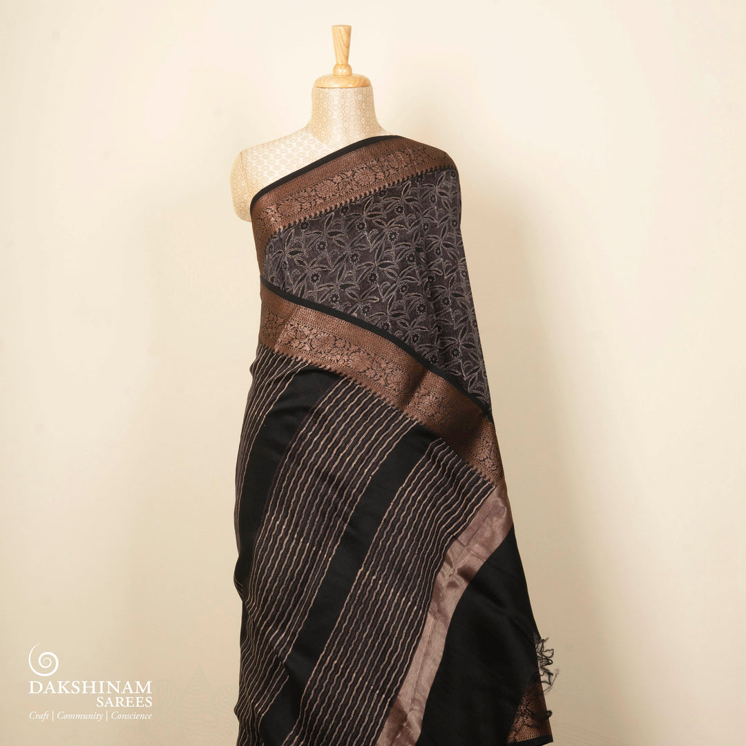 Black Chanderi silk cotton saree with white floral print, gold zari border and striped pallu