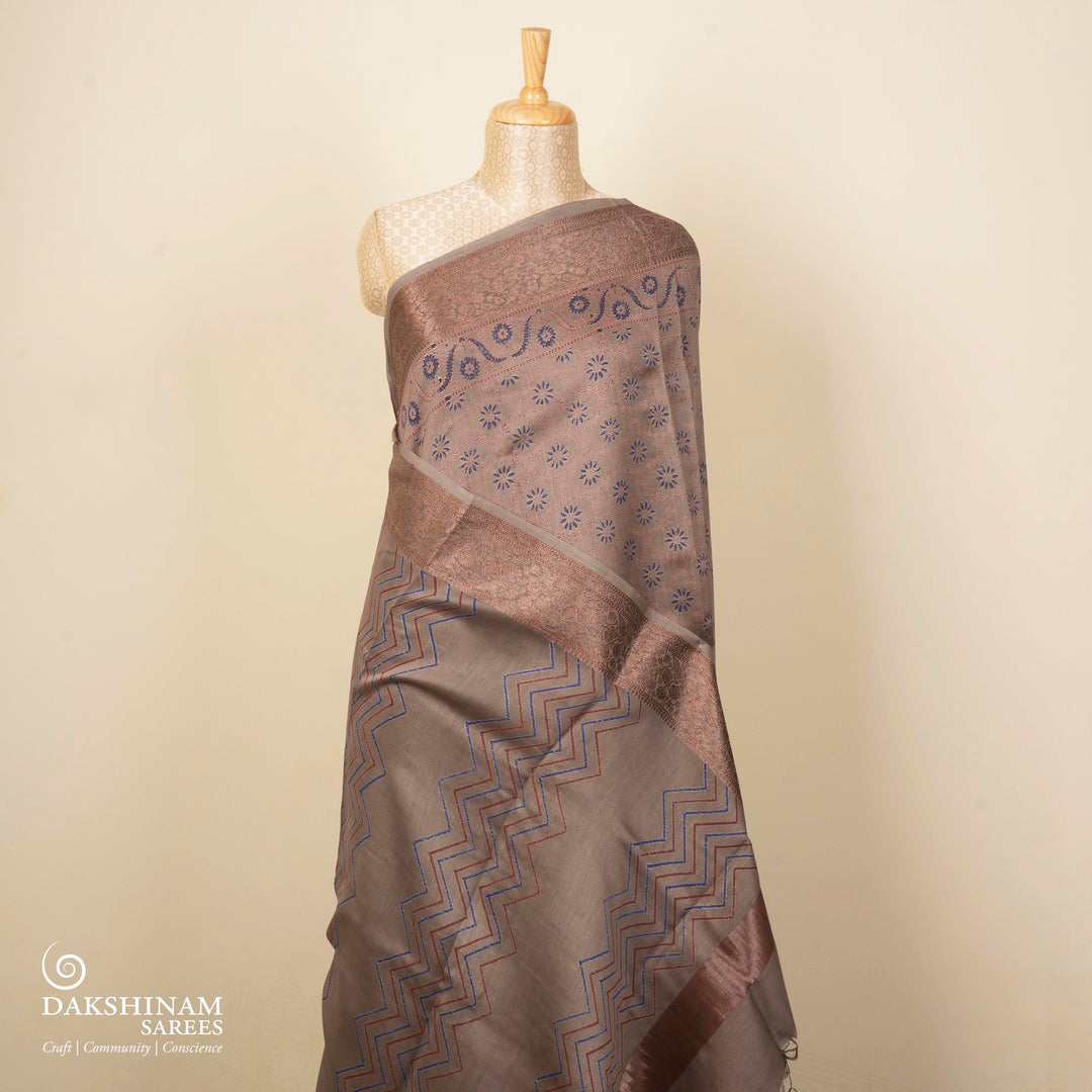 Grey Chanderi silk cotton saree with blue floral print, red diamond block print and copper zari border