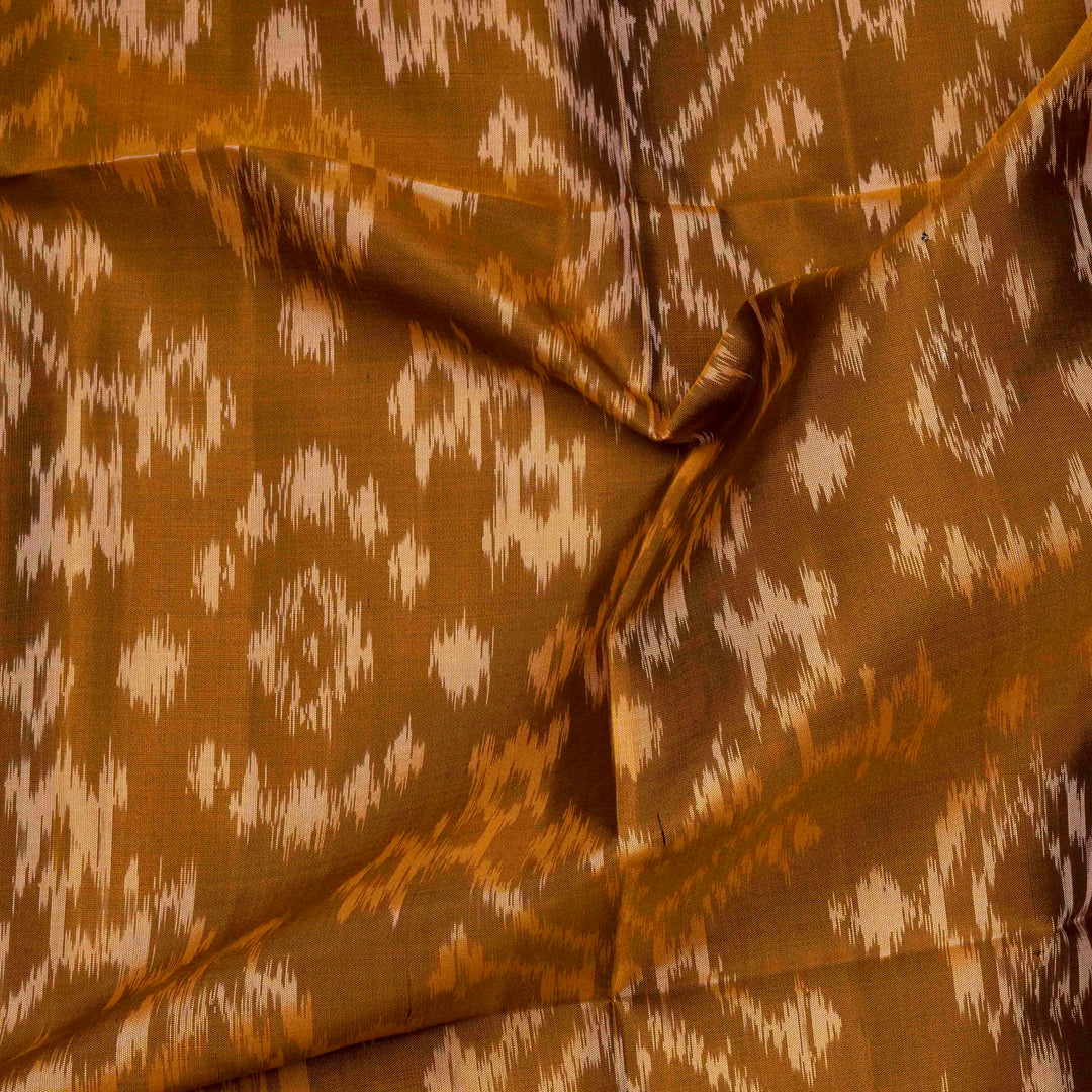 Mustard handwoven Ikat soft silk saree with white Ikat motifs and matching border