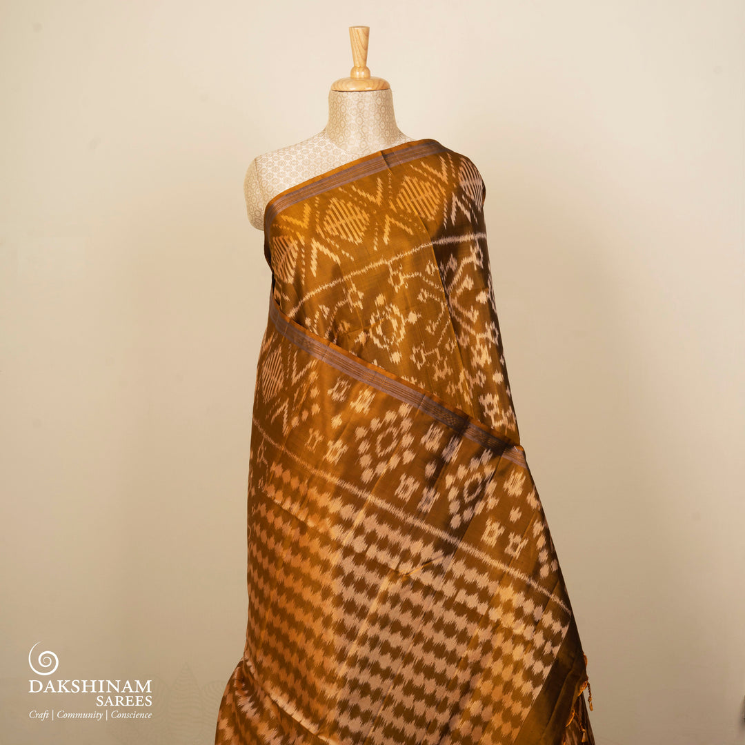 Mustard handwoven Ikat soft silk saree with white Ikat motifs and matching border