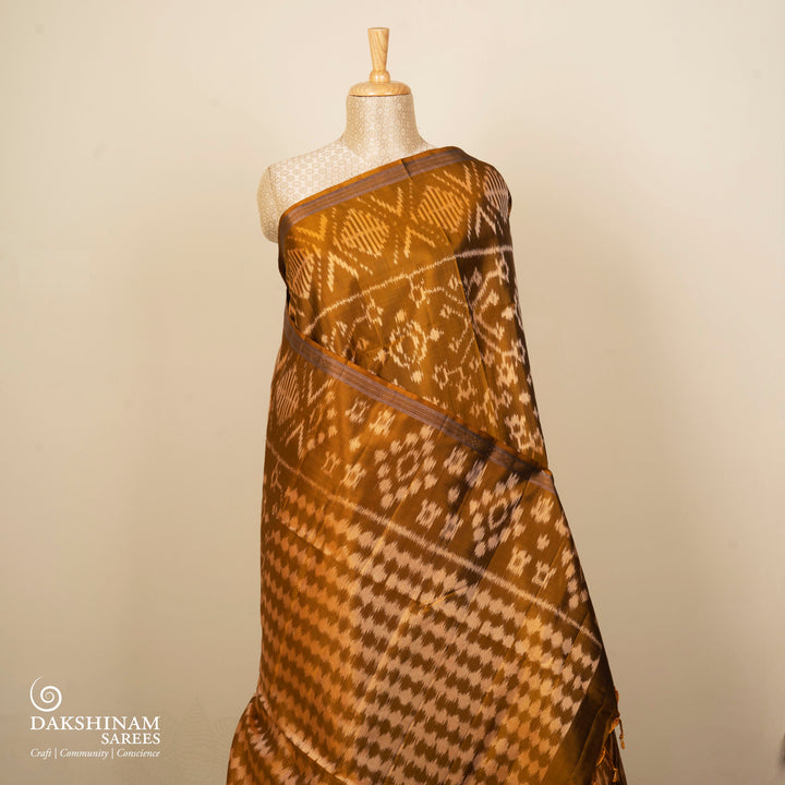 Mustard handwoven Ikat soft silk saree with white Ikat motifs and matching border