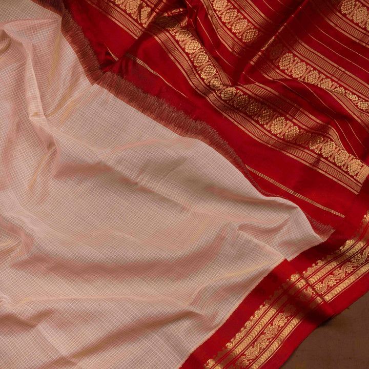 Beige checked Gadwal cotton saree with red Korvai silk border, gold zari floral motifs and red pallu