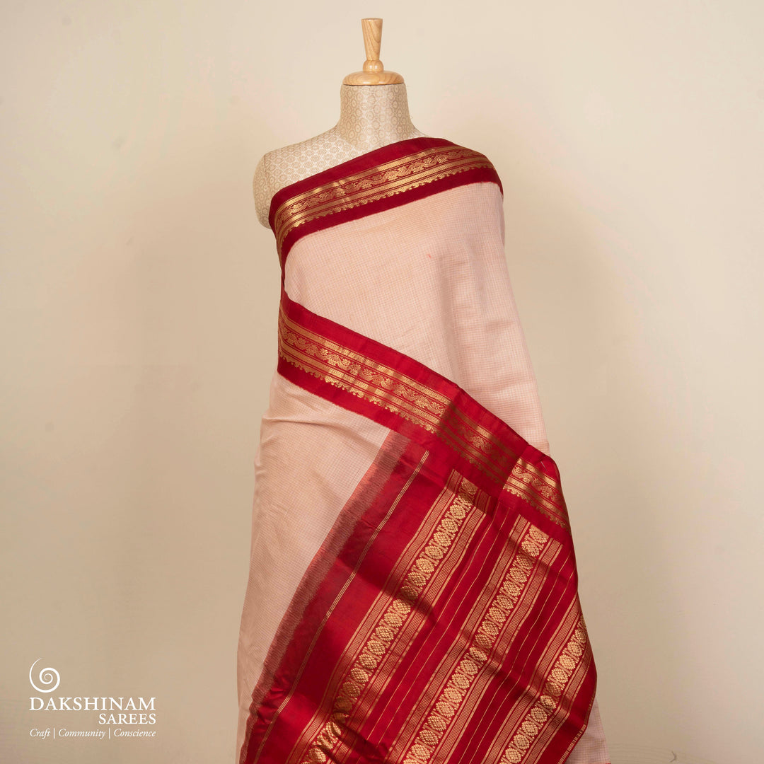 Beige checked Gadwal cotton saree with red Korvai silk border, gold zari floral motifs and red pallu