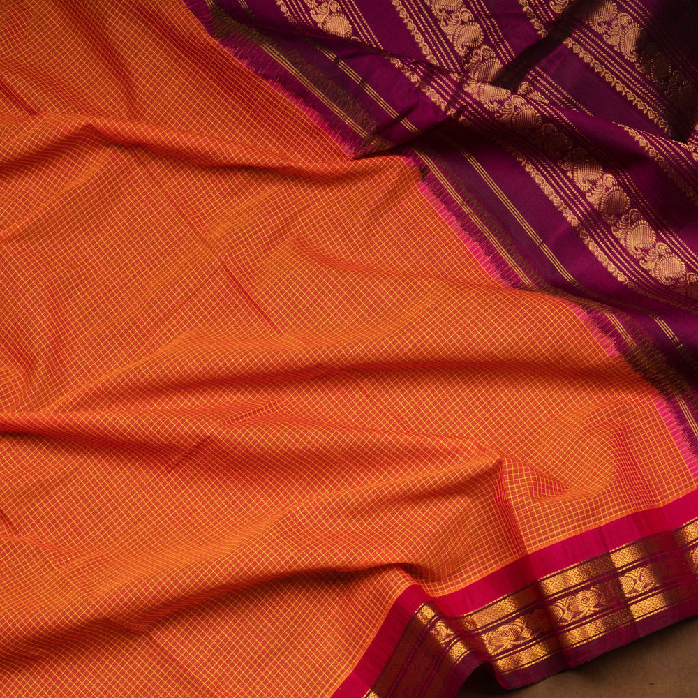 Orange Gadwal cotton saree with white checks, magenta silk border, gold zari floral motifs and striped pallu