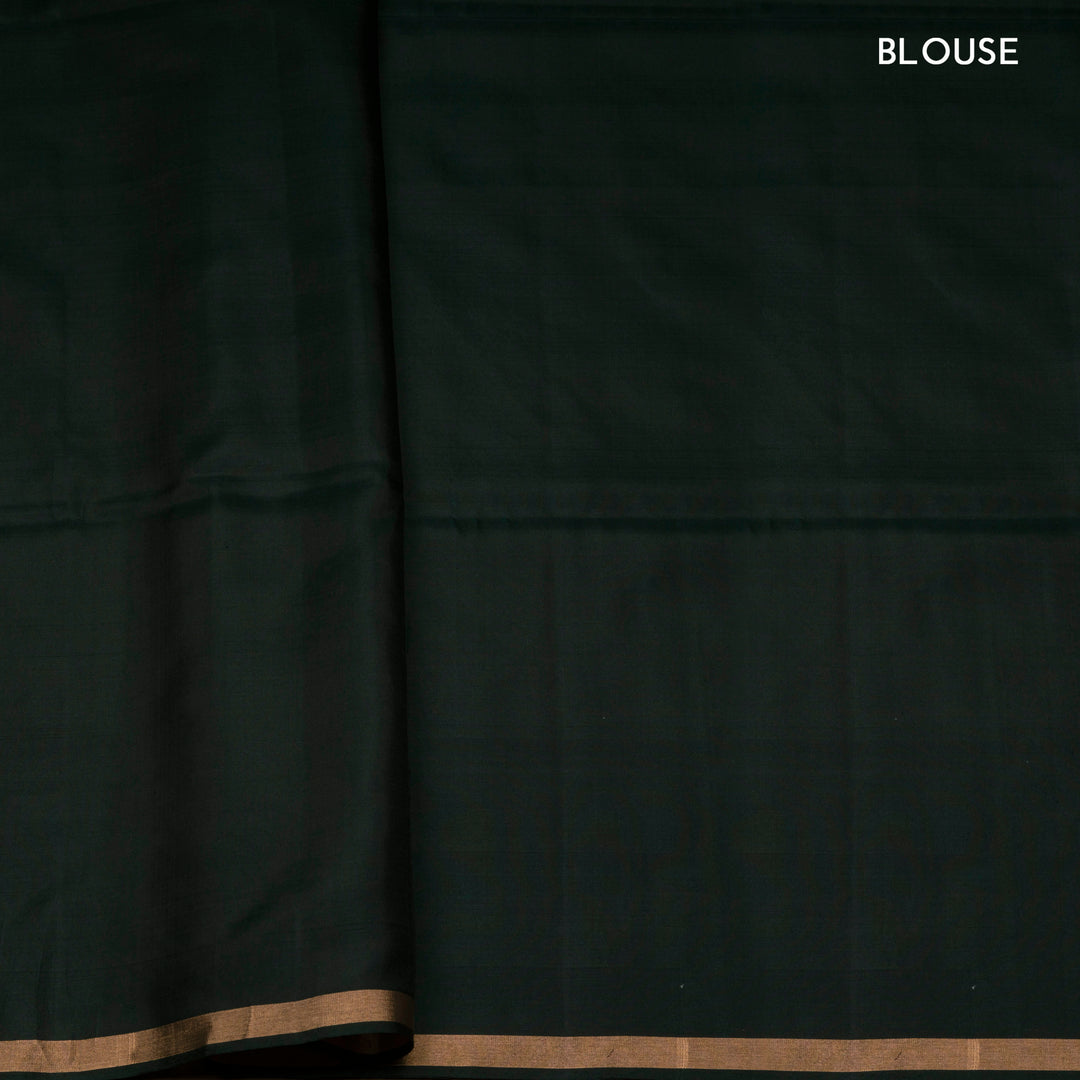 Dark green soft silk saree with gold and silver zari annam, chakram and floral motifs