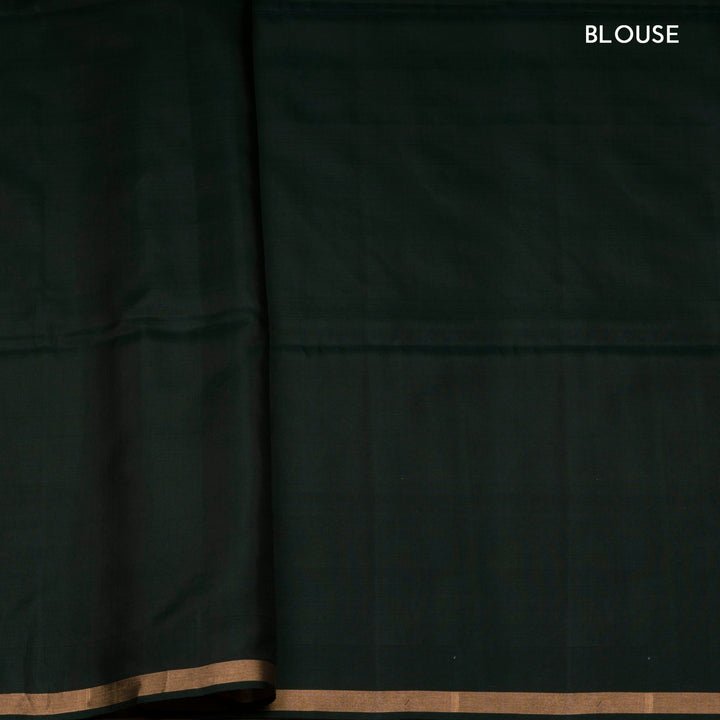 Dark green soft silk saree with gold and silver zari annam, chakram and floral motifs