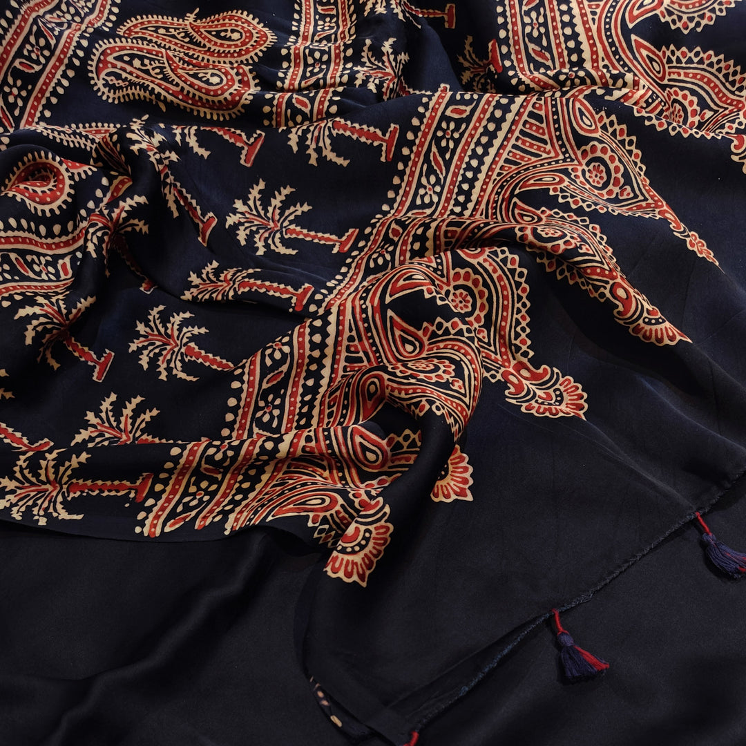 Navy blue fabric with intricate red and beige patterns