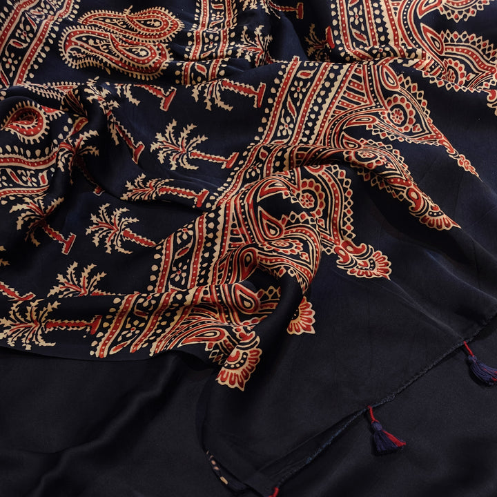 Navy blue fabric with intricate red and beige patterns