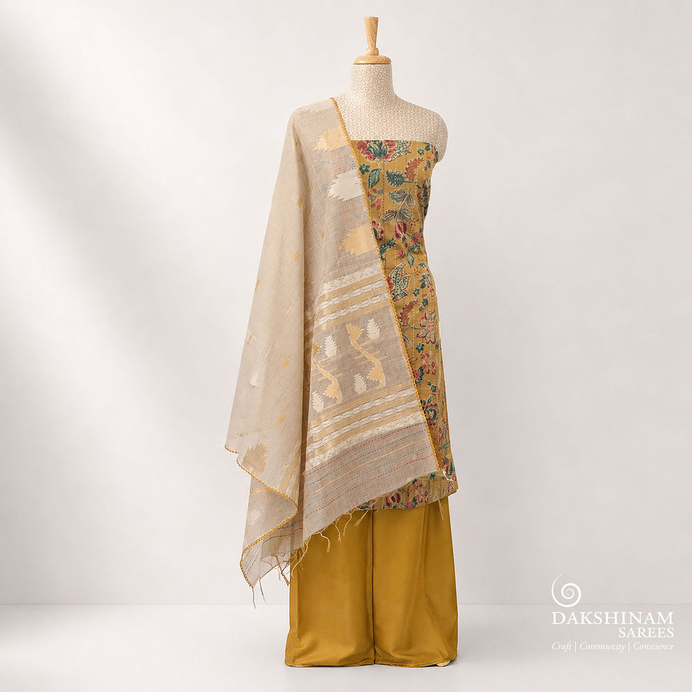 Premium mustard pure cotton 3-piece suit set featuring elegant floral prints with vertical Kantha stitch detailing and hand embroidery on the top. Paired with a plain mustard bottom and a contrasting grey dupatta, this daily wear ethnic outfit offers comfort with timeless style.