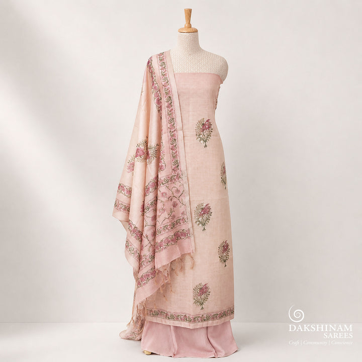 Elegant purple 3-piece suit set featuring floral prints with light orange applique work on tissue fabric. Paired with a plain purple bottom and a floral printed Chanderi silk cotton dupatta for a rich and graceful ethnic look.