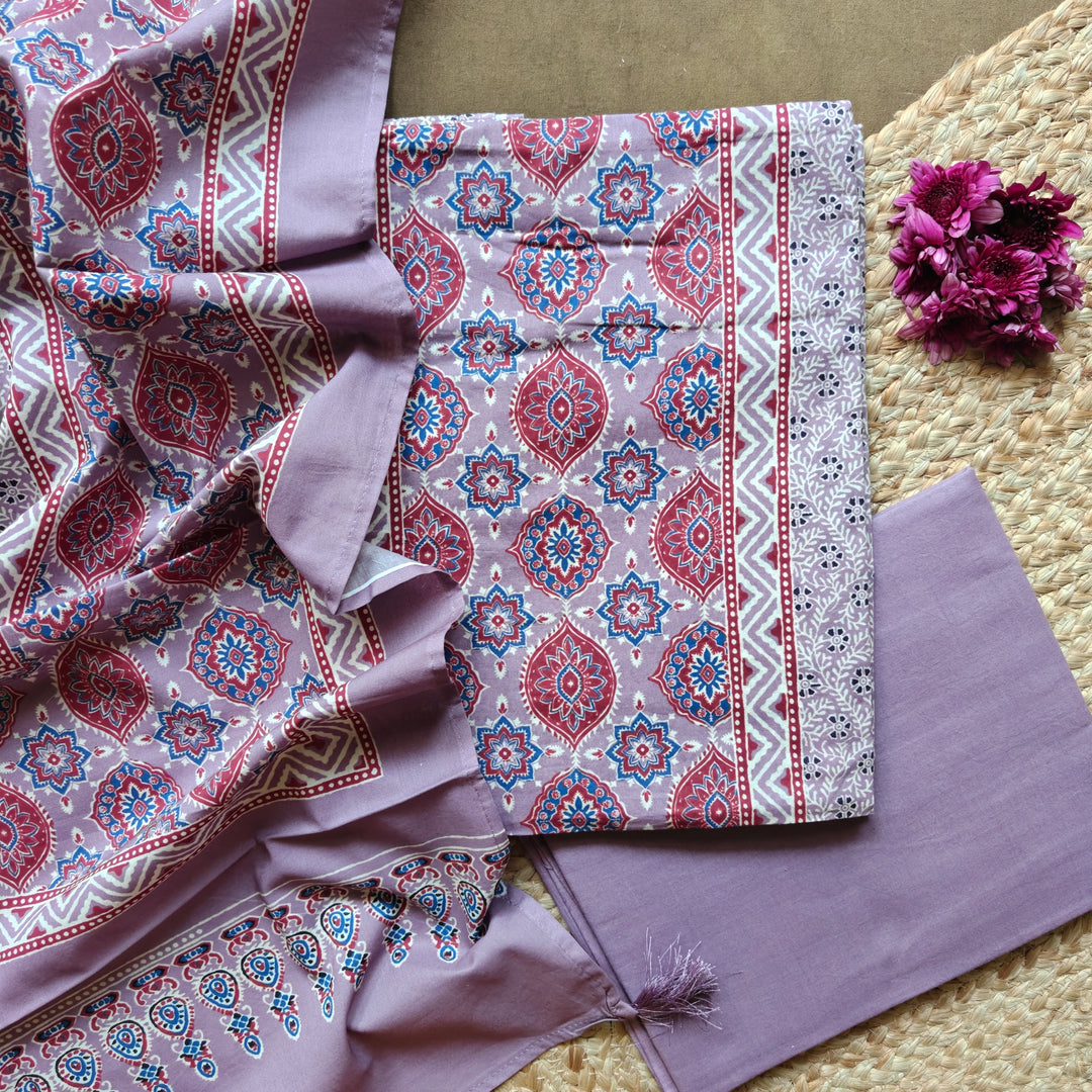 Lavender Ajrakh printed 3-piece cotton suit set with floral motifs, plain bottom and matching dupatta