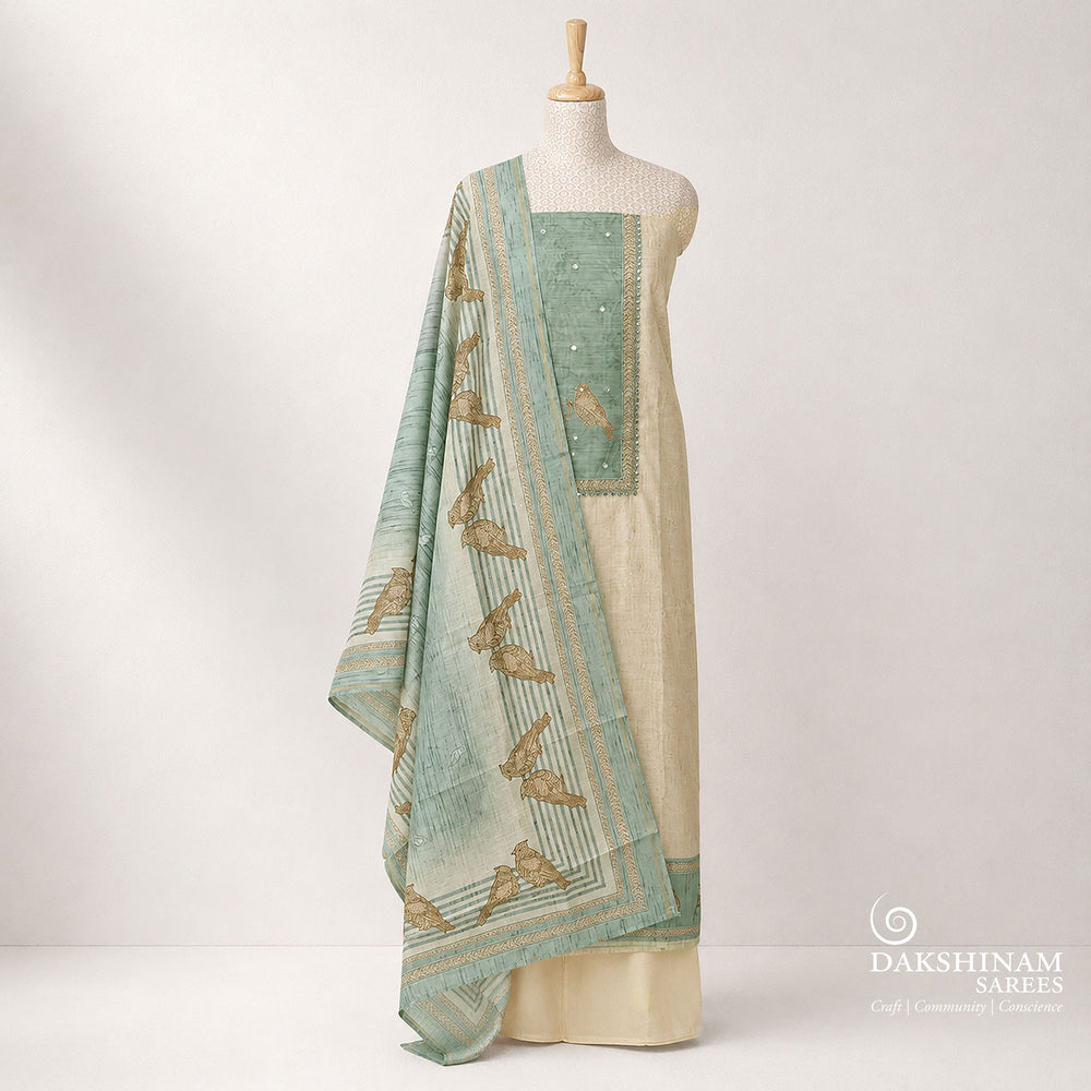 Premium beige and light blue pure cotton 3-piece suit set featuring elegant bird prints, chevron line patterns, and detailed applique work on the top. Paired with a plain beige bottom and a stylish bird printed light blue dupatta for a graceful ethnic look.