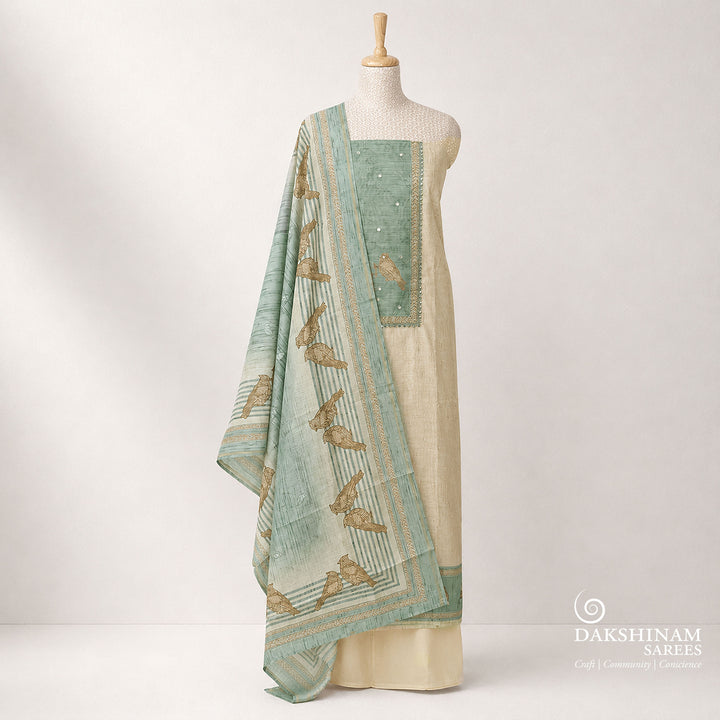 Premium beige and light blue pure cotton 3-piece suit set featuring elegant bird prints, chevron line patterns, and detailed applique work on the top. Paired with a plain beige bottom and a stylish bird printed light blue dupatta for a graceful ethnic look.