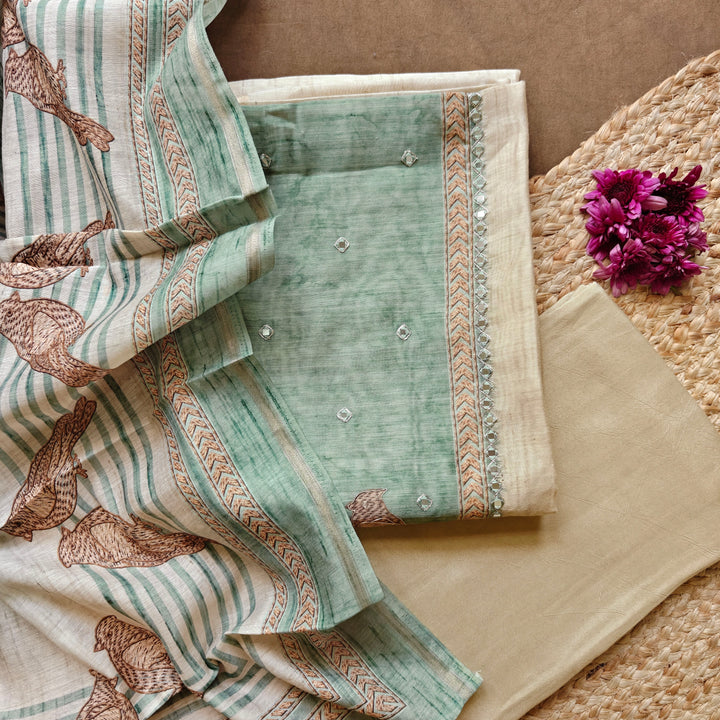 Premium beige and light blue pure cotton 3-piece suit set featuring elegant bird prints, chevron line patterns, and detailed applique work on the top. Paired with a plain beige bottom and a stylish bird printed light blue dupatta for a graceful ethnic look.