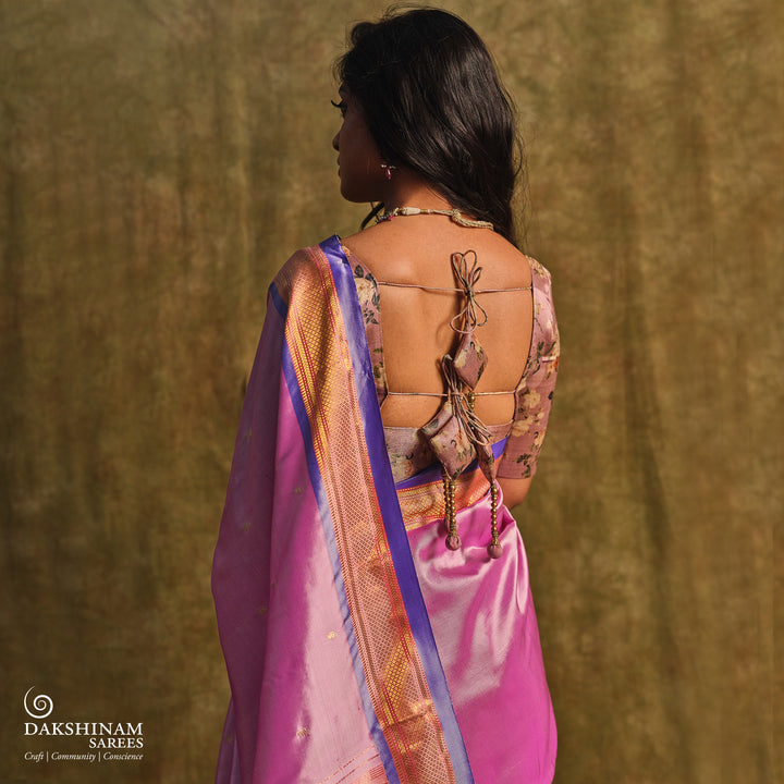 Lavender Paithani silk saree with gold zari paisley buttas, blue selvedge border with mayil motifs and traditional peacock pallu.