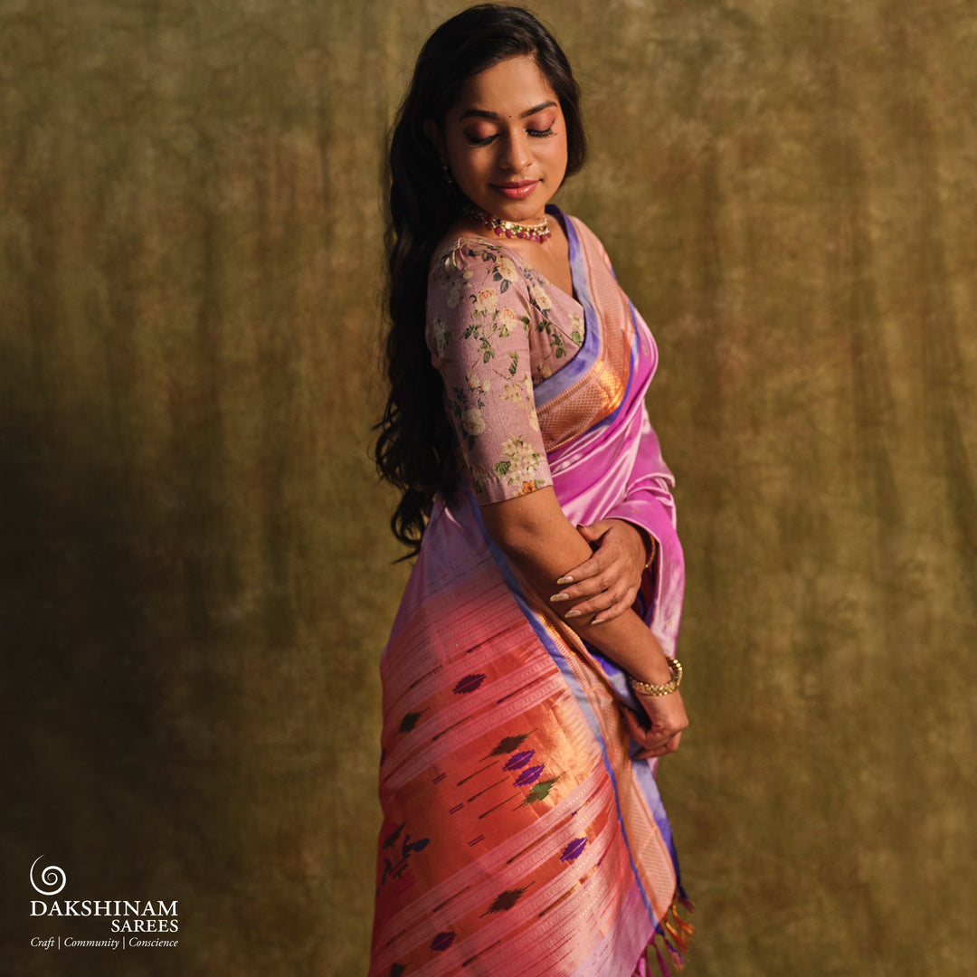 Lavender Paithani silk saree with gold zari paisley buttas, blue selvedge border with mayil motifs and traditional peacock pallu.